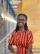 female with dark hair wearing a red dress